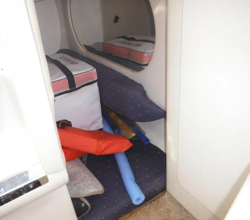 Slide: The Image of Interior cabin of 2002 Sea Ray 260 Sundancer with life jackets and pool noodles. - 47