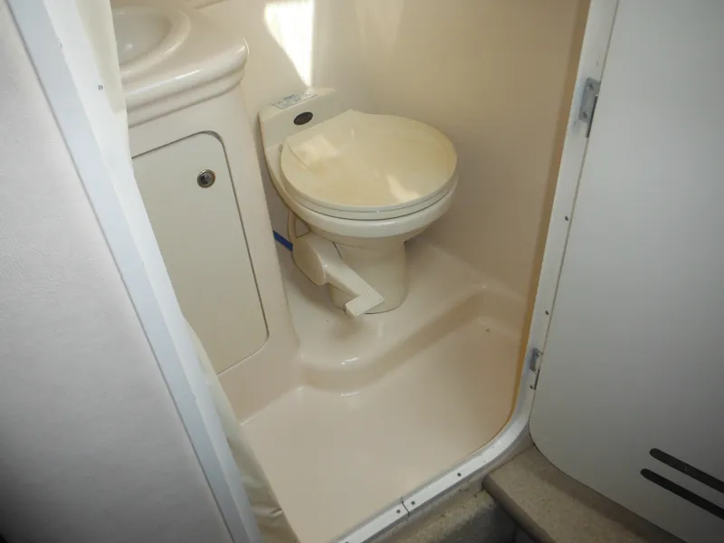 Slide: The Image of 2002 Sea Ray 260 Sundancer boat bathroom with toilet and sink. - 48