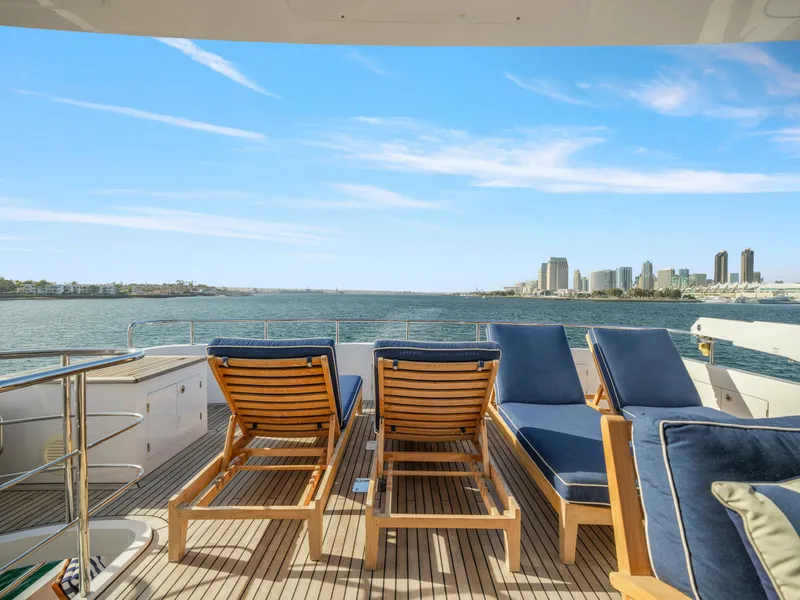 Slide: The Image of Luxury yacht deck with lounge chairs overlooking city skyline and ocean, President Sterling 2011 model. - 12