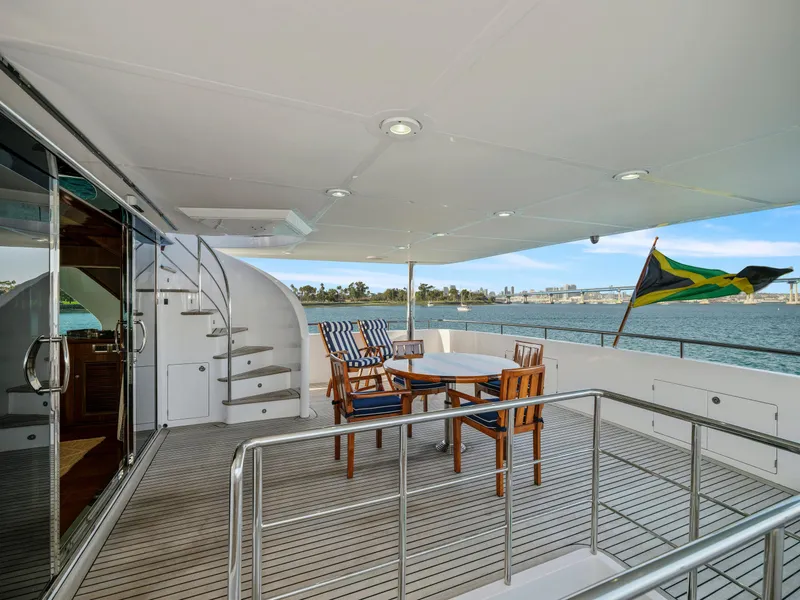 Slide: The Image of Luxurious 2011 President Sterling yacht deck with seating, ocean view, and flag. - 24