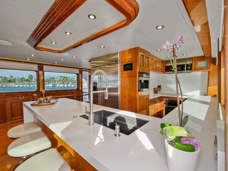 Slide: The Image of Luxurious yacht kitchen interior with modern appliances, wood accents, and scenic window view. - 44