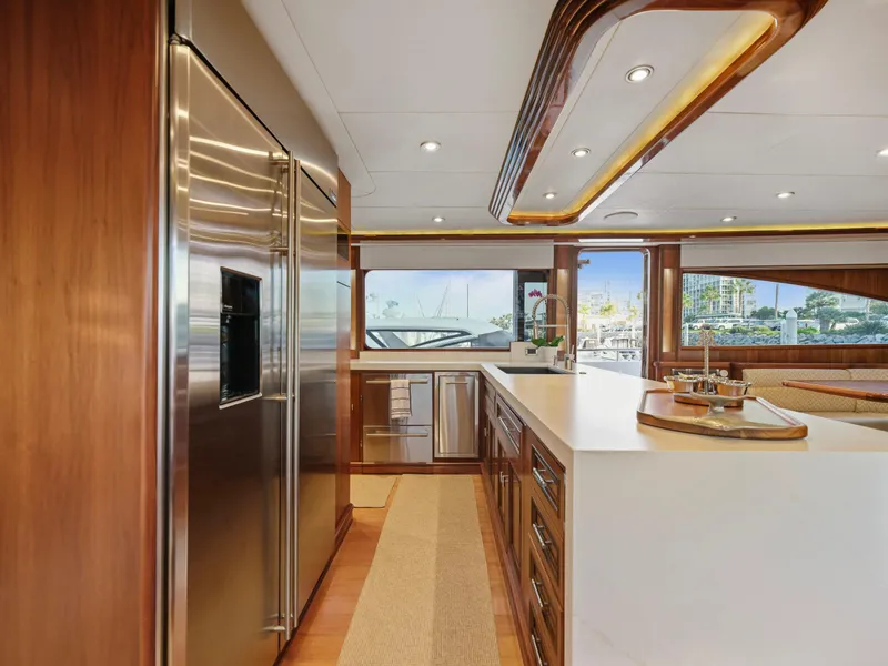 Slide: The Image of Luxurious yacht kitchen interior with stainless steel appliances, wooden cabinetry, and large windows. - 46