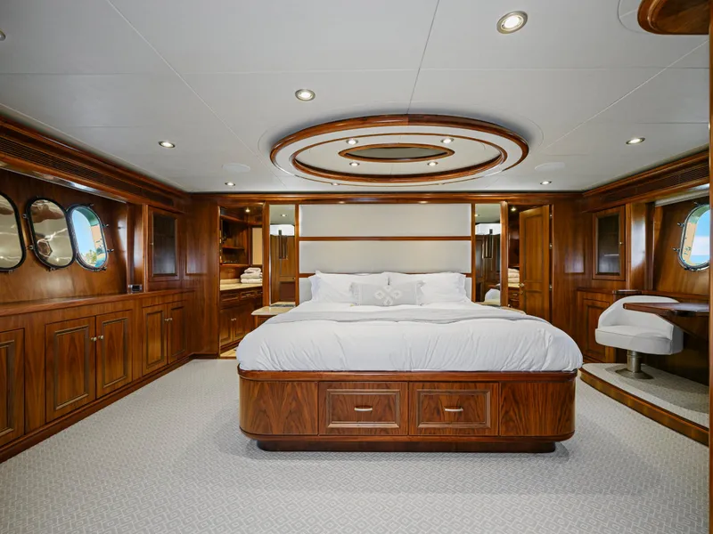 Slide: The Image of Luxurious yacht bedroom with elegant wood paneling, circular ceiling design, and plush bedding. - 50
