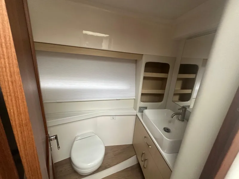 Slide: The Image of Modern bathroom interior of 2025 Regal 38 Grande Coupe yacht, featuring sleek fixtures and storage. - 11