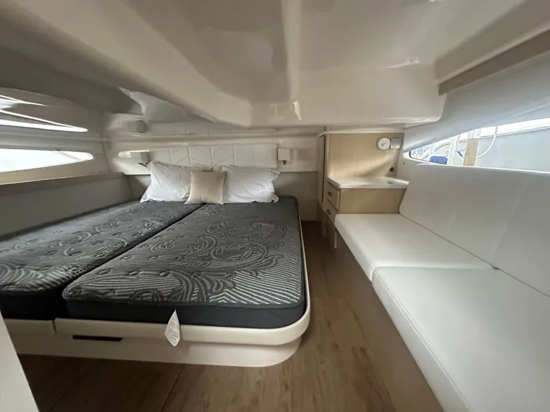 Slide: The Image of 2025 Regal 38 Grande Coupe interior cabin with bed and seating area. - 7