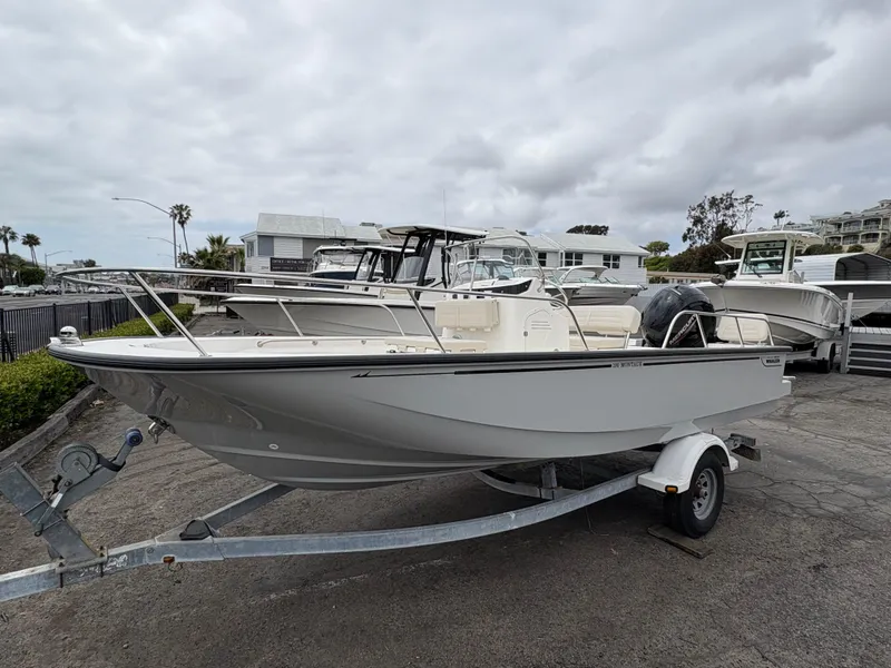The Image of 2025 Boston Whaler 190 Montauk boat on trailer, parked outdoors under cloudy sky. - 0