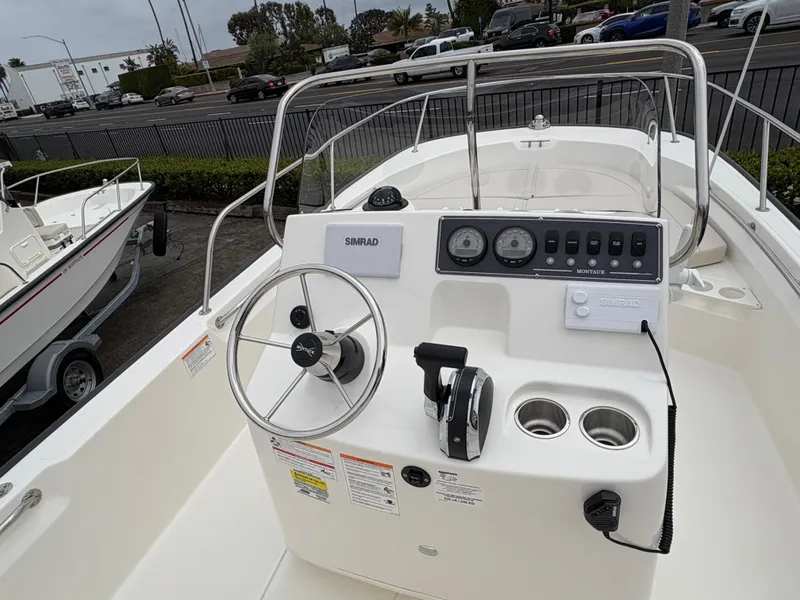 Slide: The Image of 2025 Boston Whaler 190 Montauk boat console with steering wheel and controls. - 6