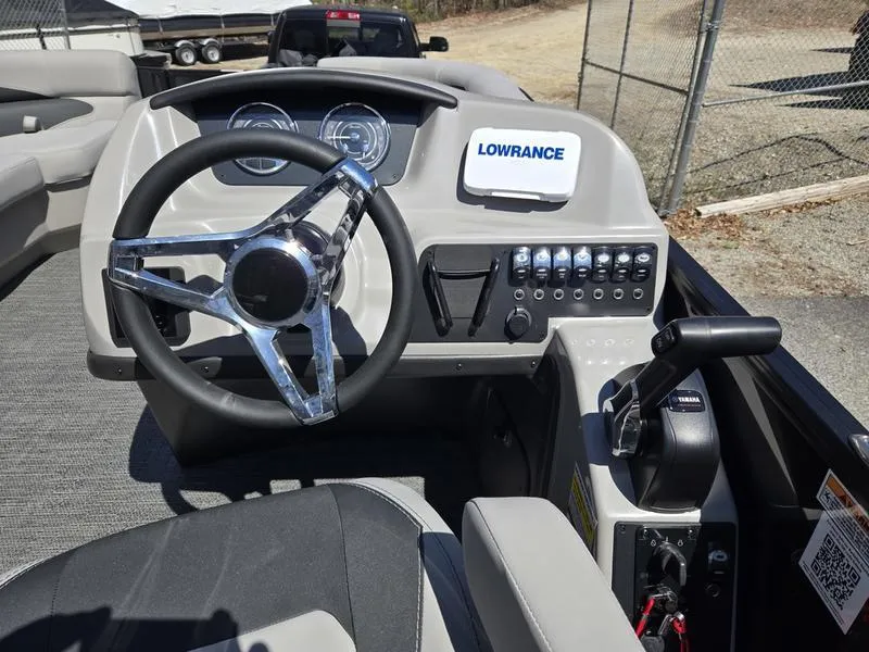 Slide: The Image of 2025 Barletta A22QC boat dashboard with steering wheel and Lowrance navigation system. - 8