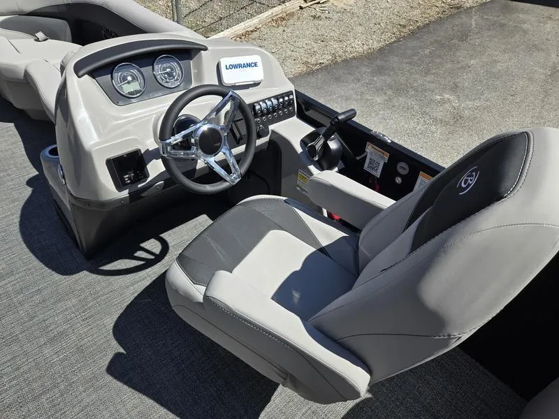 Slide: The Image of 2025 Barletta A22QC boat cockpit with steering wheel and control panel. - 9