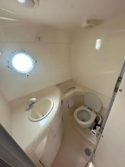 Slide: The Image of 2003 Trophy 2902 Walkaround boat bathroom with sink and toilet. - 12