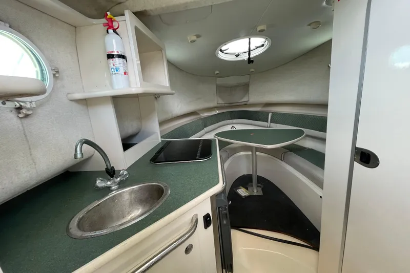 Slide: The Image of 2003 Trophy 2902 Walkaround cabin interior with kitchenette and seating area. - 5