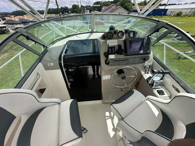 Slide: The Image of 2003 Trophy 2902 Walkaround boat cockpit with steering wheel and navigation equipment. - 8