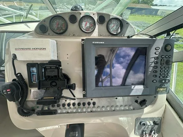 Slide: The Image of 2003 Trophy 2902 Walkaround boat dashboard with navigation equipment and gauges. - 9