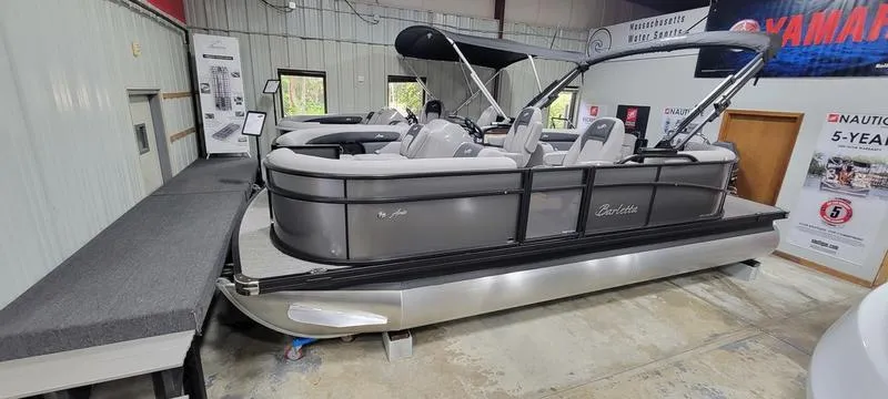 Slide: The Image of 2025 Barletta A20QC pontoon boat displayed indoors at a showroom. - 3