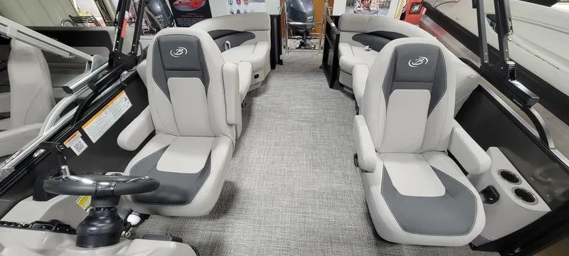 Slide: The Image of Interior of 2025 Barletta A20QC boat with modern seating and steering wheel. - 7