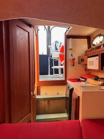 Slide: The Image of Interior of 1996 Albemarle 27 Express boat with kitchenette and wooden cabinetry. - 10