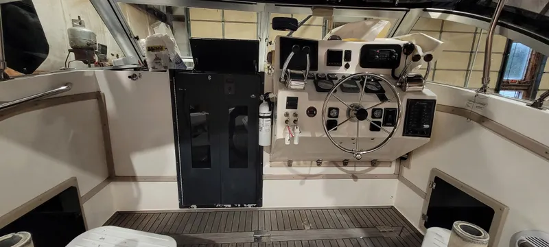 Slide: The Image of 1996 Albemarle 27 Express boat cockpit with steering wheel and control panel. - 11