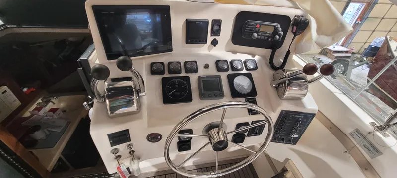 Slide: The Image of 1996 Albemarle 27 Express boat dashboard with steering wheel and navigation controls. - 12