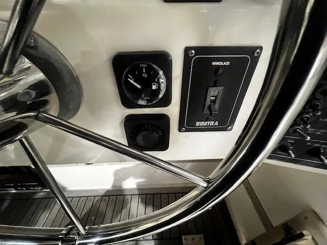 Slide: The Image of Steering wheel and controls of a 1996 Albemarle 27 Express boat. - 14