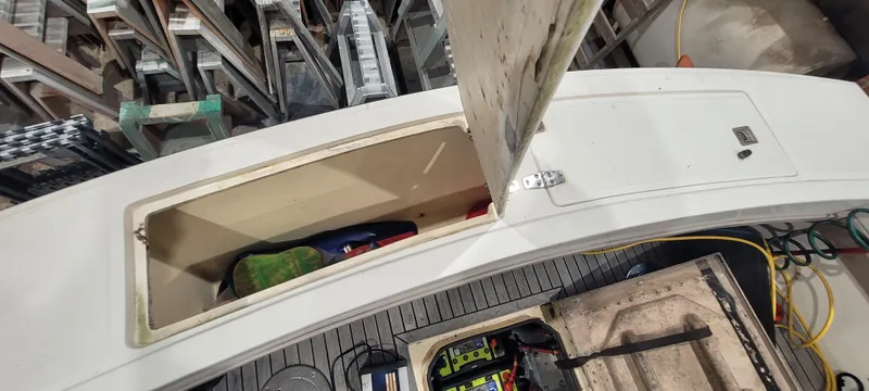 Slide: The Image of 1996 Albemarle 27 Express boat storage compartments with open hatches and visible equipment. - 23