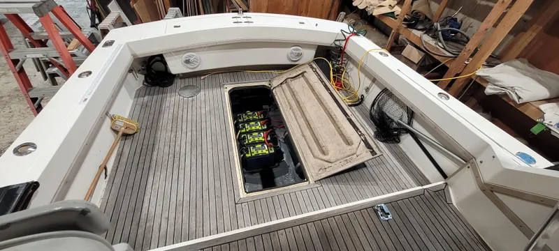Slide: The Image of 1996 Albemarle 27 Express boat deck with open hatch revealing batteries. - 24