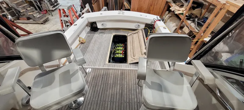 Slide: The Image of 1996 Albemarle 27 Express boat interior with two seats and open hatch. - 26