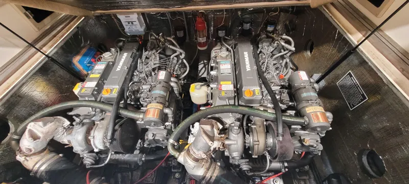 Slide: The Image of Engine compartment of a 1996 Albemarle 27 Express boat, featuring twin inboard engines. - 29