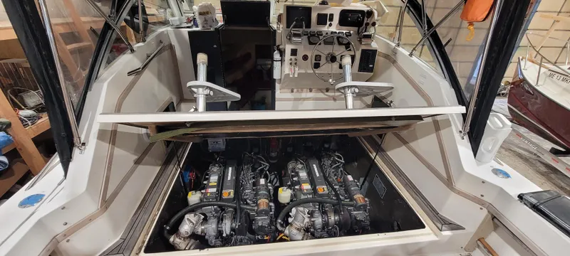 Slide: The Image of 1996 Albemarle 27 Express boat engine compartment with dual engines and cockpit controls. - 32