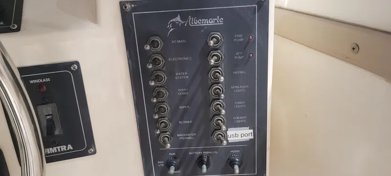 Slide: The Image of Control panel of a 1996 Albemarle 27 Express boat with various switches and labels. - 35