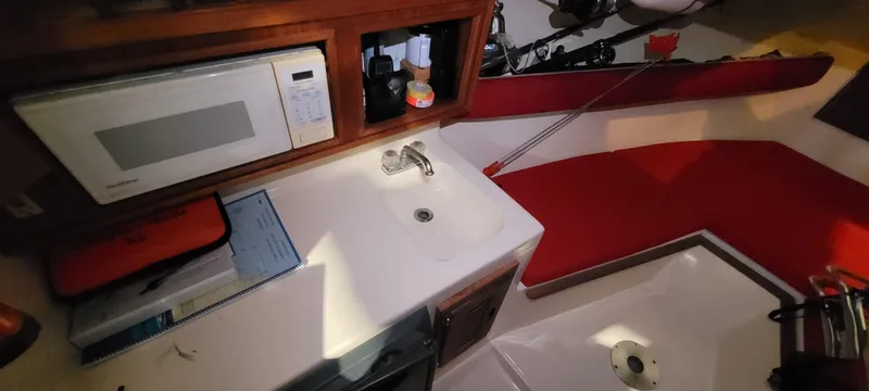 Slide: The Image of Interior of 1996 Albemarle 27 Express boat with kitchenette and red seating. - 4