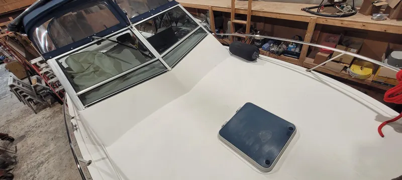 Slide: The Image of 1996 Albemarle 27 Express boat deck in storage, featuring a hatch and windshield. - 41