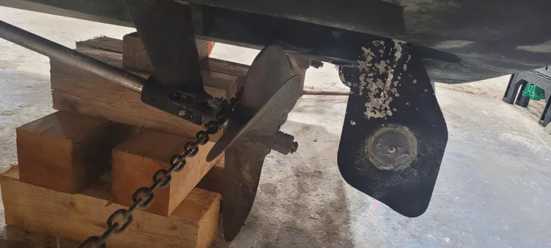 Slide: The Image of 1996 Albemarle 27 Express boat propeller and rudder on wooden blocks in a garage. - 42