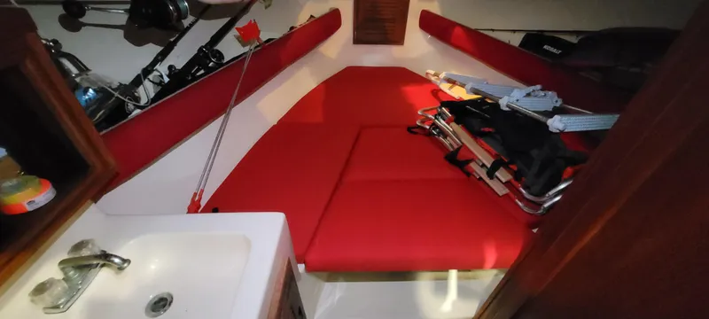 Slide: The Image of Interior of a 1996 Albemarle 27 Express boat with red seating and a small sink. - 6