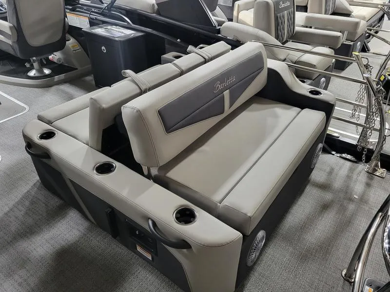 Slide: The Image of 2025 Barletta C24UE boat interior with gray seating and cup holders. - 11