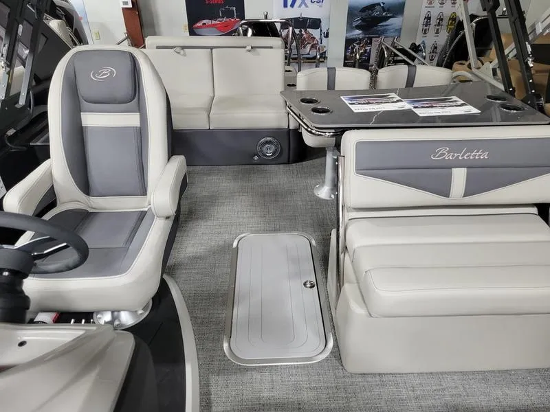 Slide: The Image of 2025 Barletta C24UE boat interior with gray seating and table. - 13