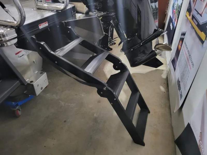 Slide: The Image of Barletta C24UE 2025 boat ladder and motor in showroom display. - 15