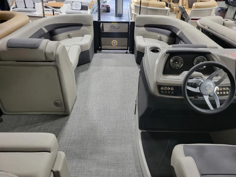 Slide: The Image of 2025 Barletta C24UE pontoon boat interior with plush seating and modern dashboard. - 22