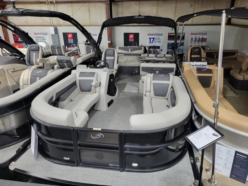 Slide: The Image of 2025 Barletta C24UE pontoon boat with spacious seating and modern design in showroom. - 3