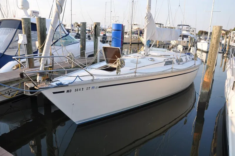 The Image of 1989 Hunter Legend 40 sailboat docked in marina, calm water reflections. - 0