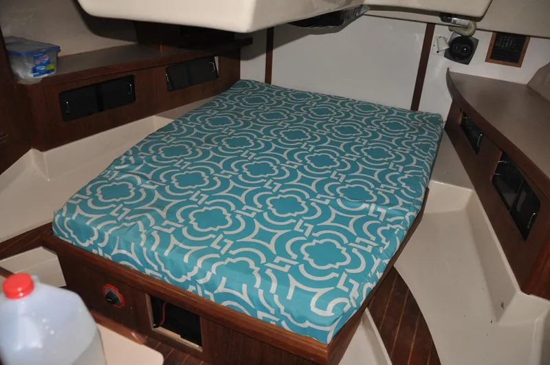 Slide: The Image of Interior cabin of 1989 Hunter Legend 40 sailboat with patterned bedspread. - 12