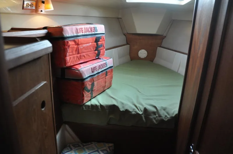 Slide: The Image of Interior cabin of 1989 Hunter Legend 40 sailboat with life jackets on bed. - 13