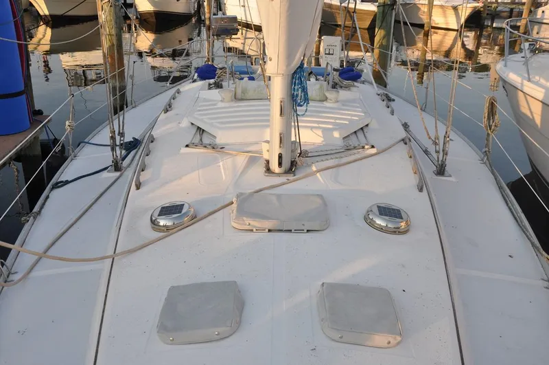 Slide: The Image of 1989 Hunter Legend 40 sailboat deck with rigging and hatches in marina. - 4