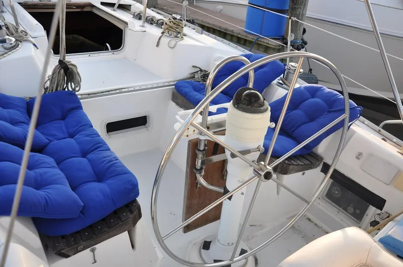 Slide: The Image of 1989 Hunter Legend 40 sailboat cockpit with blue cushions and steering wheel. - 5
