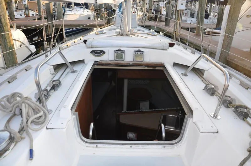 Slide: The Image of 1989 Hunter Legend 40 sailboat deck with open cabin entrance at marina. - 6