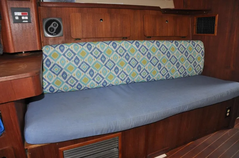 Slide: The Image of 1989 Hunter Legend 40 interior with patterned cushion and wooden cabinetry. - 8