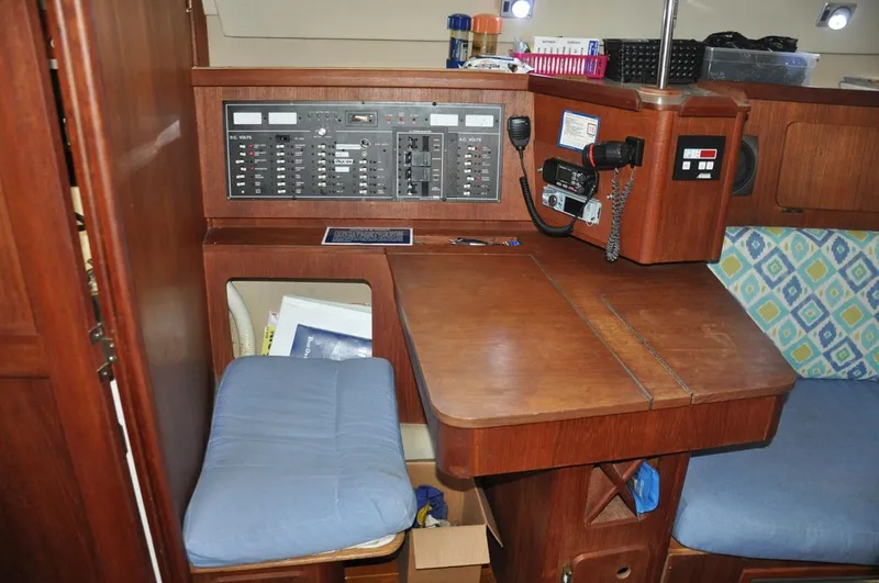 Slide: The Image of 1989 Hunter Legend 40 yacht interior with navigation station and seating area. - 9