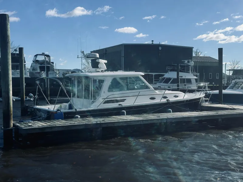 Slide: The Image of 2015 Back Cove 34 Express docked at marina under clear sky. - 10