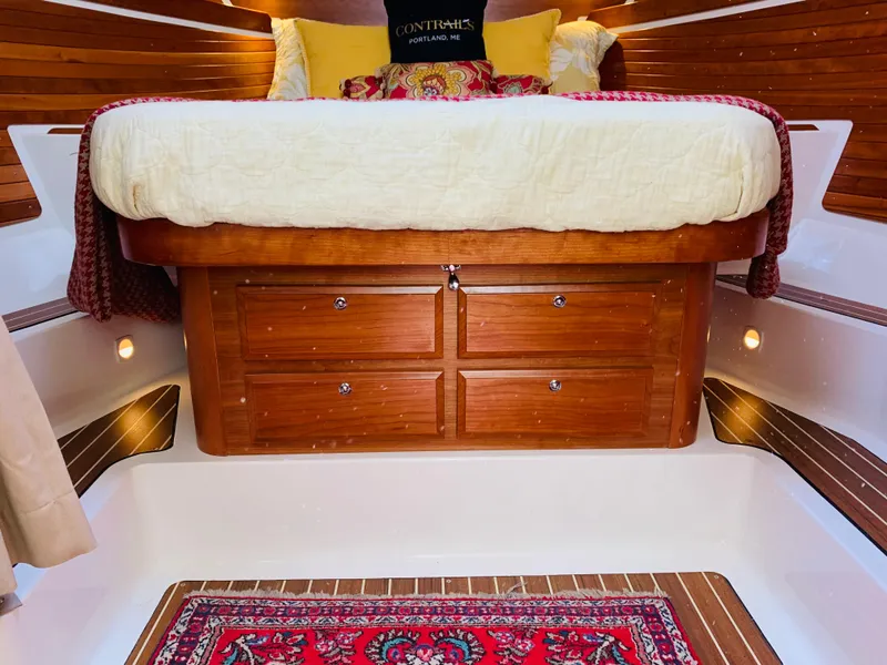 Slide: The Image of Luxurious cabin interior of 2015 Back Cove 34 Express with cozy bed and wooden accents. - 15