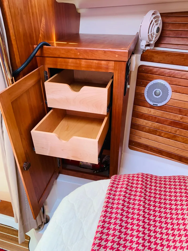 Slide: The Image of 2015 Back Cove 34 Express interior with open wooden cabinet and drawers. - 18