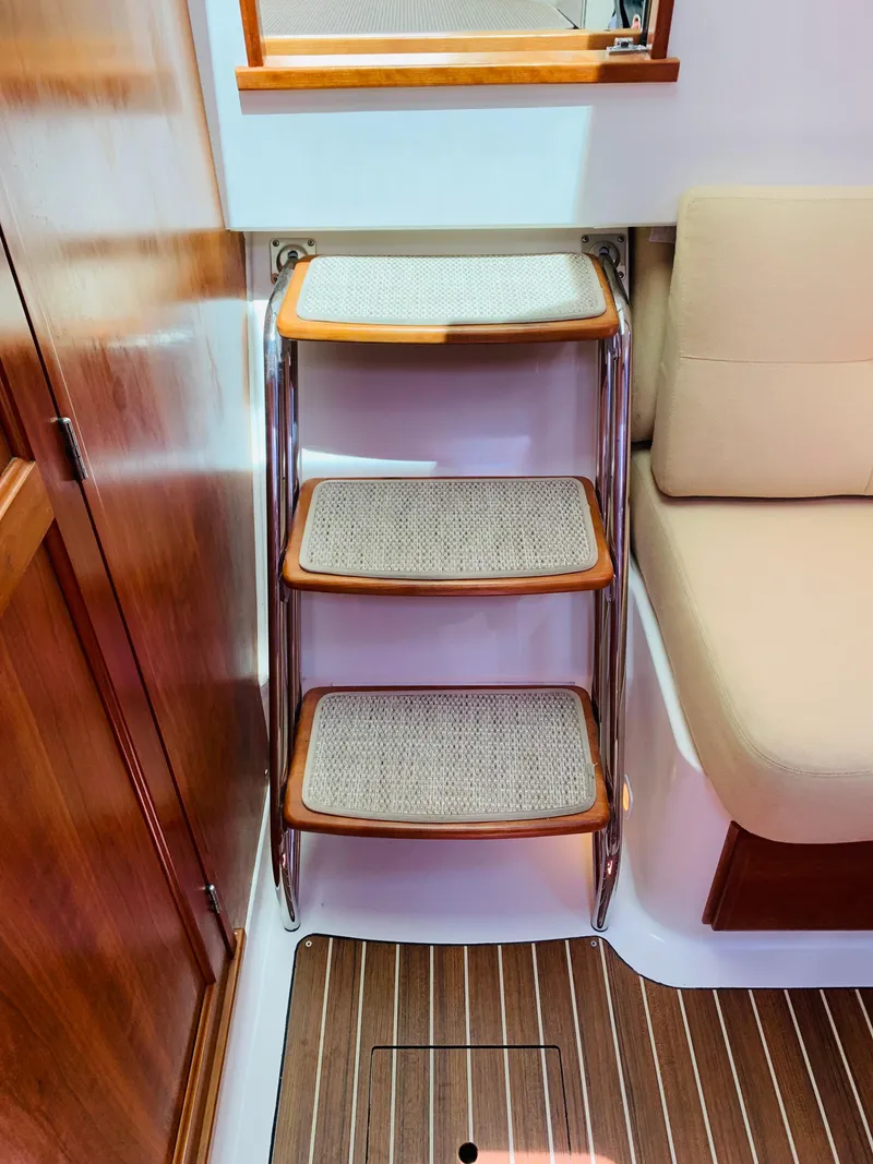 Slide: The Image of Interior of 2015 Back Cove 34 Express with wooden steps and seating. - 23